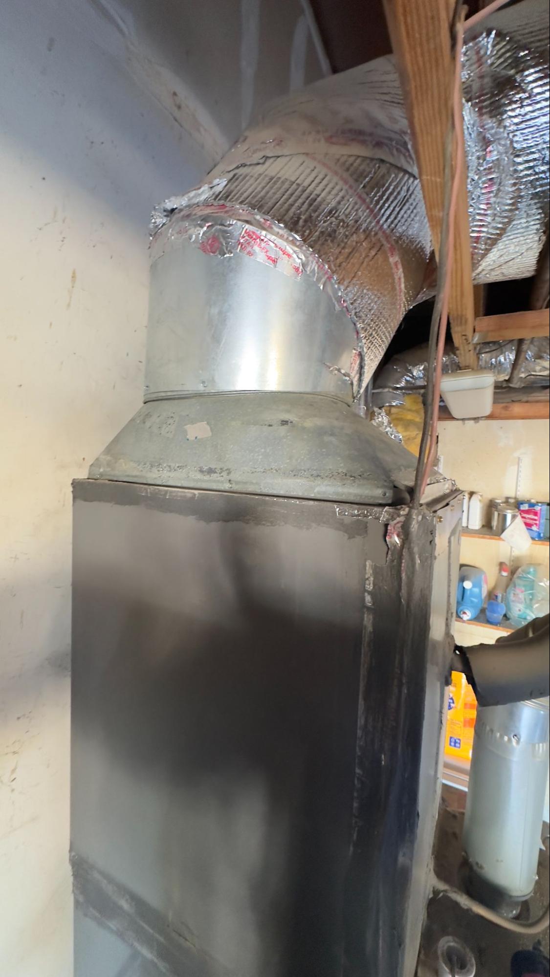 Close-up of a duct connection to the air handler, illustrating airflow efficiency points checked before AC installation
