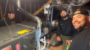 Origin Heating & Air technicians inspecting ductwork and equipment during an AC installation in Palmdale