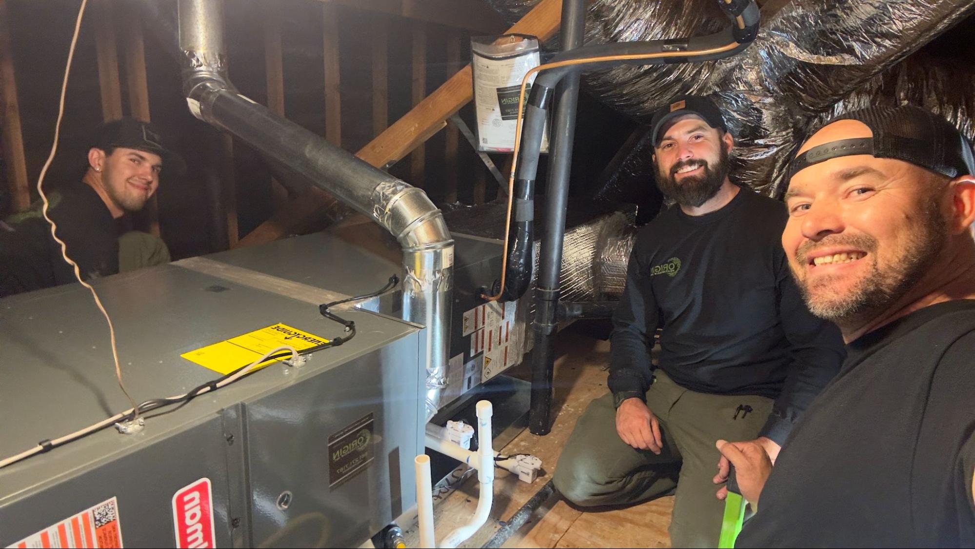 Origin Heating & Air technicians inspecting ductwork and equipment during an AC installation in Palmdale