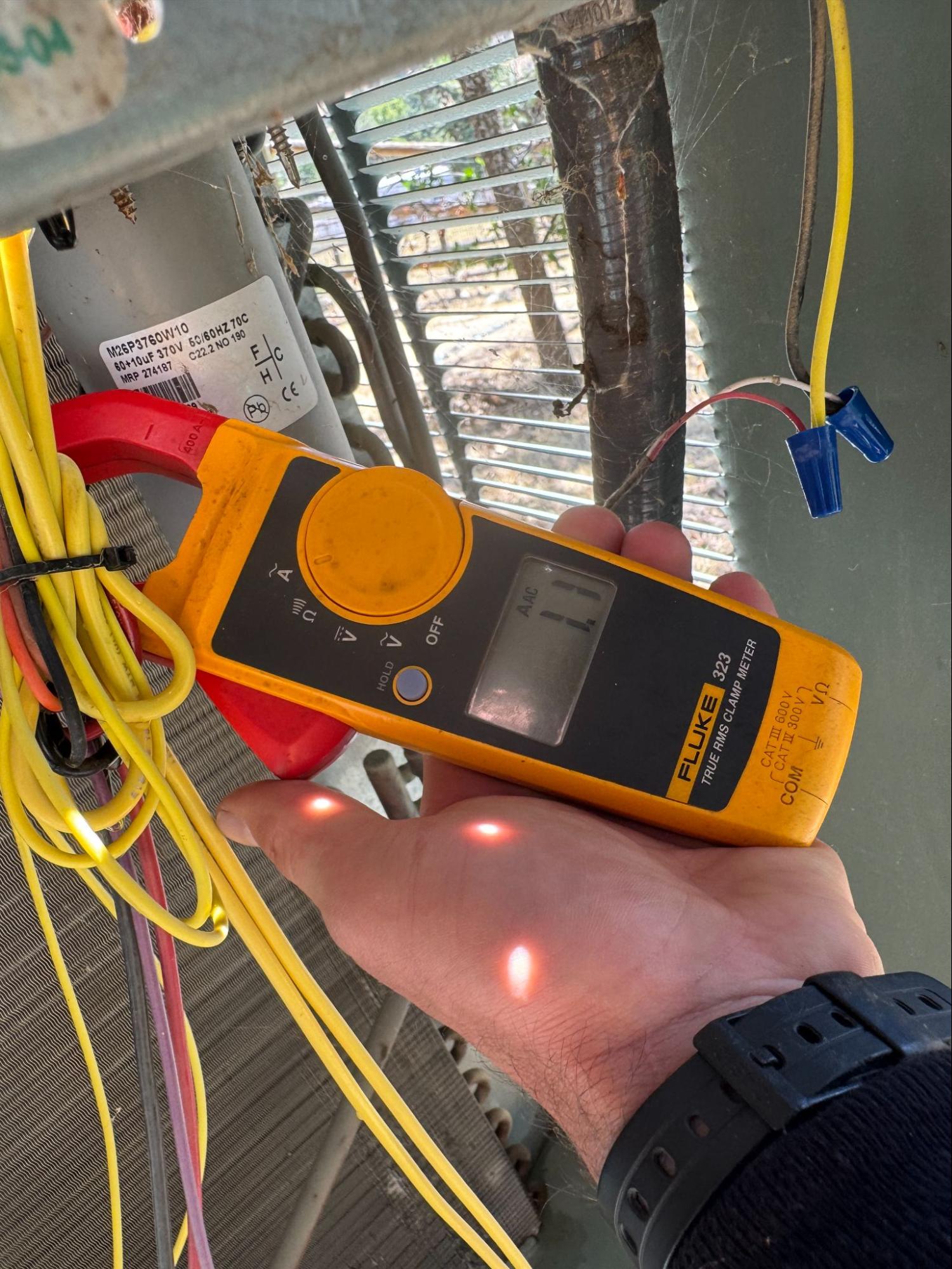 Clamp meter testing AC electrical current draw in Palmdale, CA by Origin Heating & Air