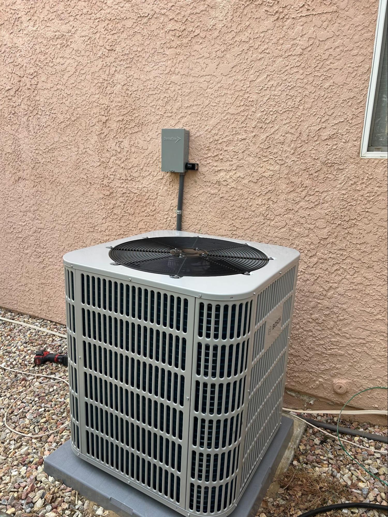 Bosch AC condenser unit installation outside stucco home in Tehachapi, CA by Origin Heating & Air
