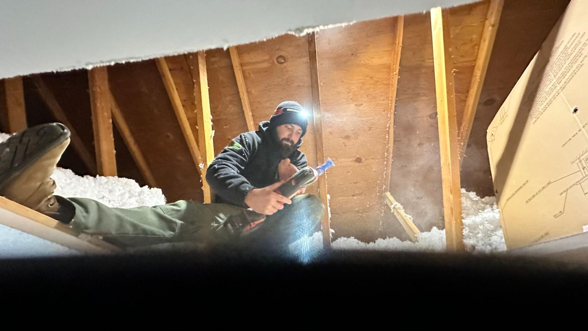 Technician performing attic insulation and air sealing work in Tehachapi, CA by Origin Heating & Air